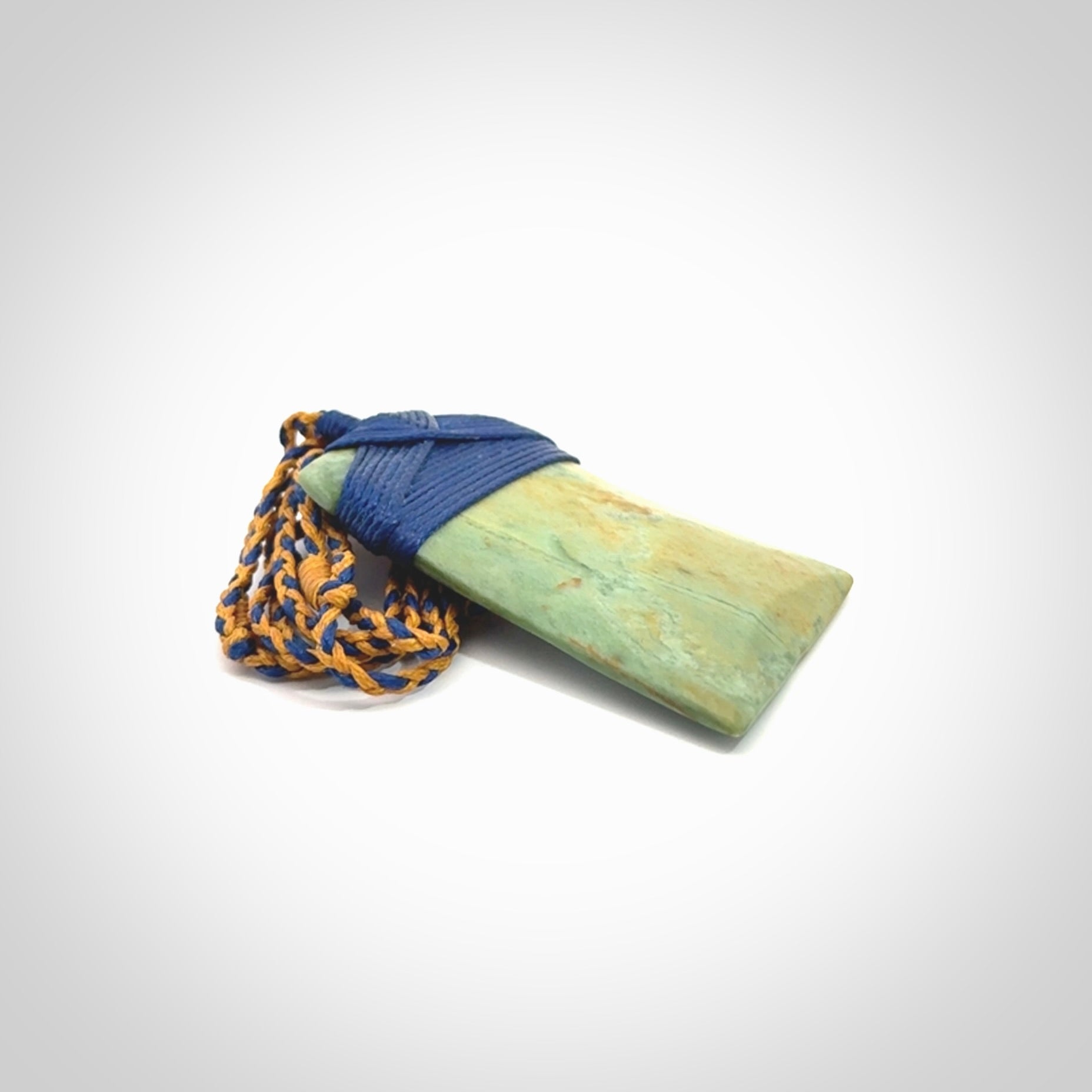 Hand carved Toki pendant from a lovely piece of local New Zealand Flower Jade. We have suspended this from a 4-plait beige cord which can be adjusted with a couple of slip knots and beige binding.