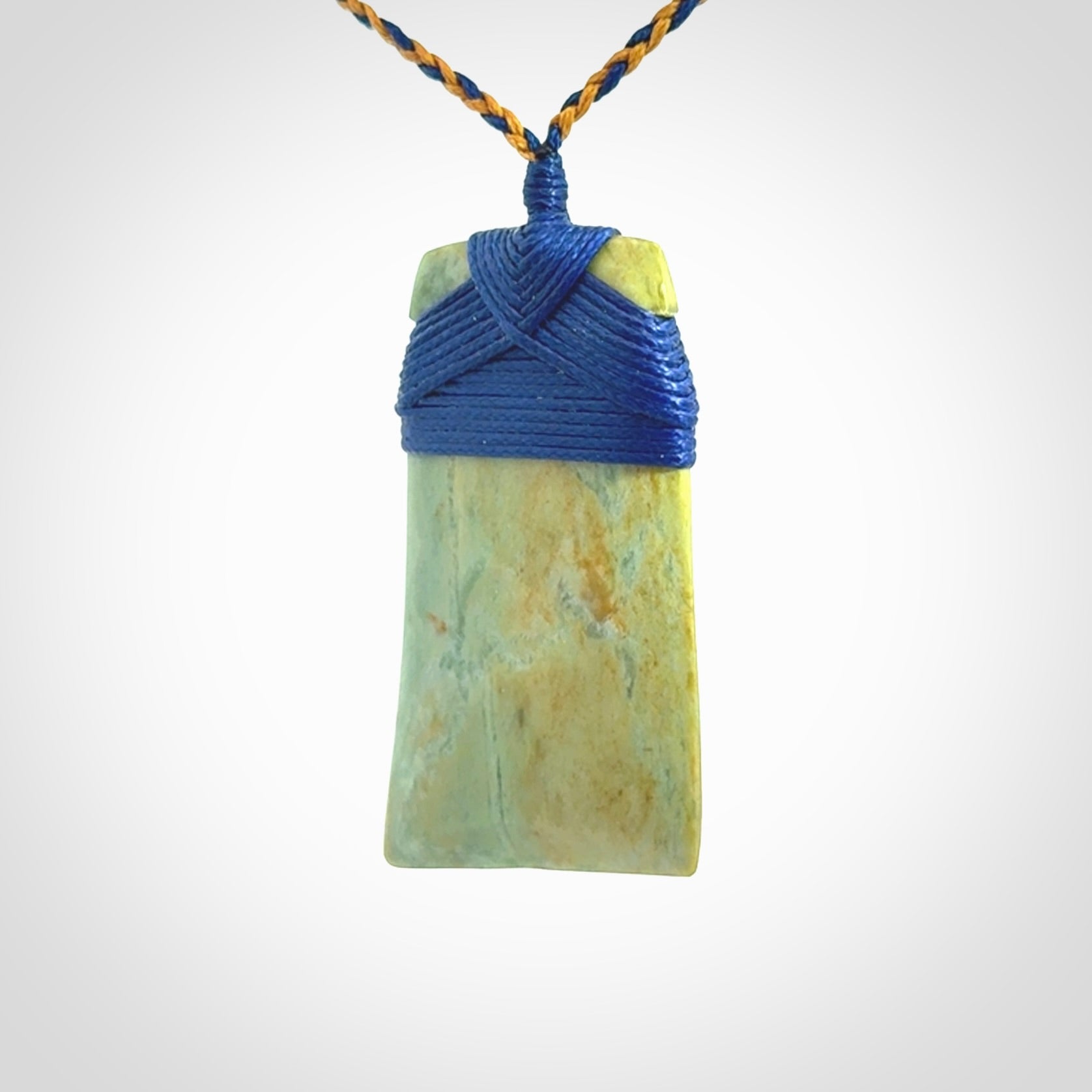 Hand carved Toki pendant from a lovely piece of local New Zealand Flower Jade. We have suspended this from a 4-plait beige cord which can be adjusted with a couple of slip knots and beige binding.