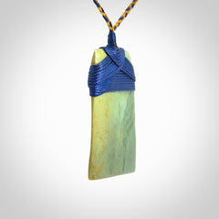 Hand carved Toki pendant from a lovely piece of local New Zealand Flower Jade. We have suspended this from a 4-plait beige cord which can be adjusted with a couple of slip knots and beige binding.