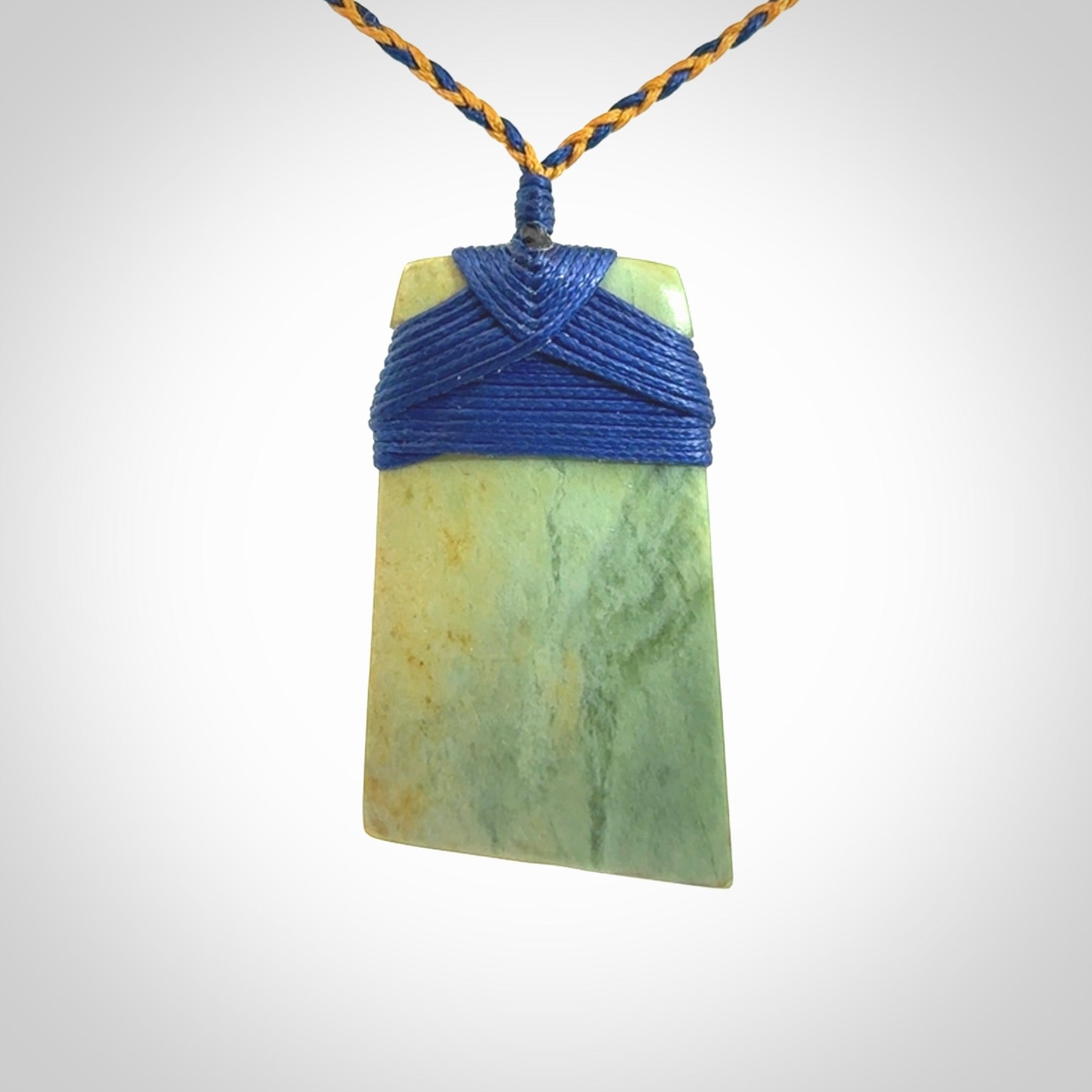 Hand carved Toki pendant from a lovely piece of local New Zealand Flower Jade. We have suspended this from a 4-plait beige cord which can be adjusted with a couple of slip knots and beige binding.
