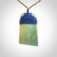 Hand carved Toki pendant from a lovely piece of local New Zealand Flower Jade. We have suspended this from a 4-plait beige cord which can be adjusted with a couple of slip knots and beige binding.