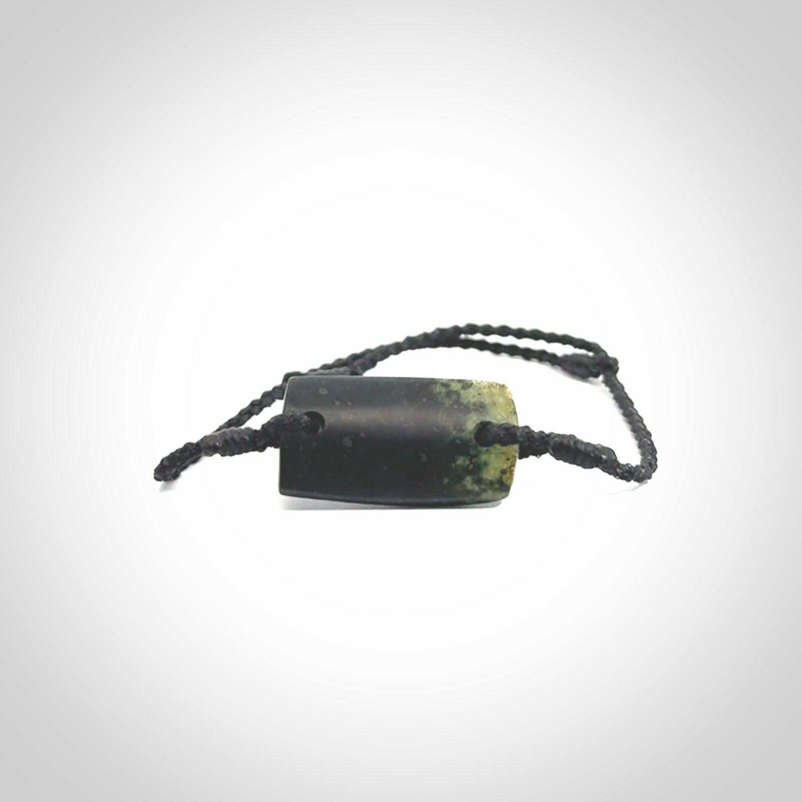 Hand carved New Zealand jade adjustable bracelet with black cord. Carved in New Zealand jade by Ric Moor for NZ Pacific. One only armband for women and men.