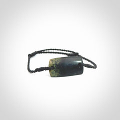 Hand carved New Zealand jade adjustable bracelet with black cord. Carved in New Zealand jade by Ric Moor for NZ Pacific. One only armband for women and men.