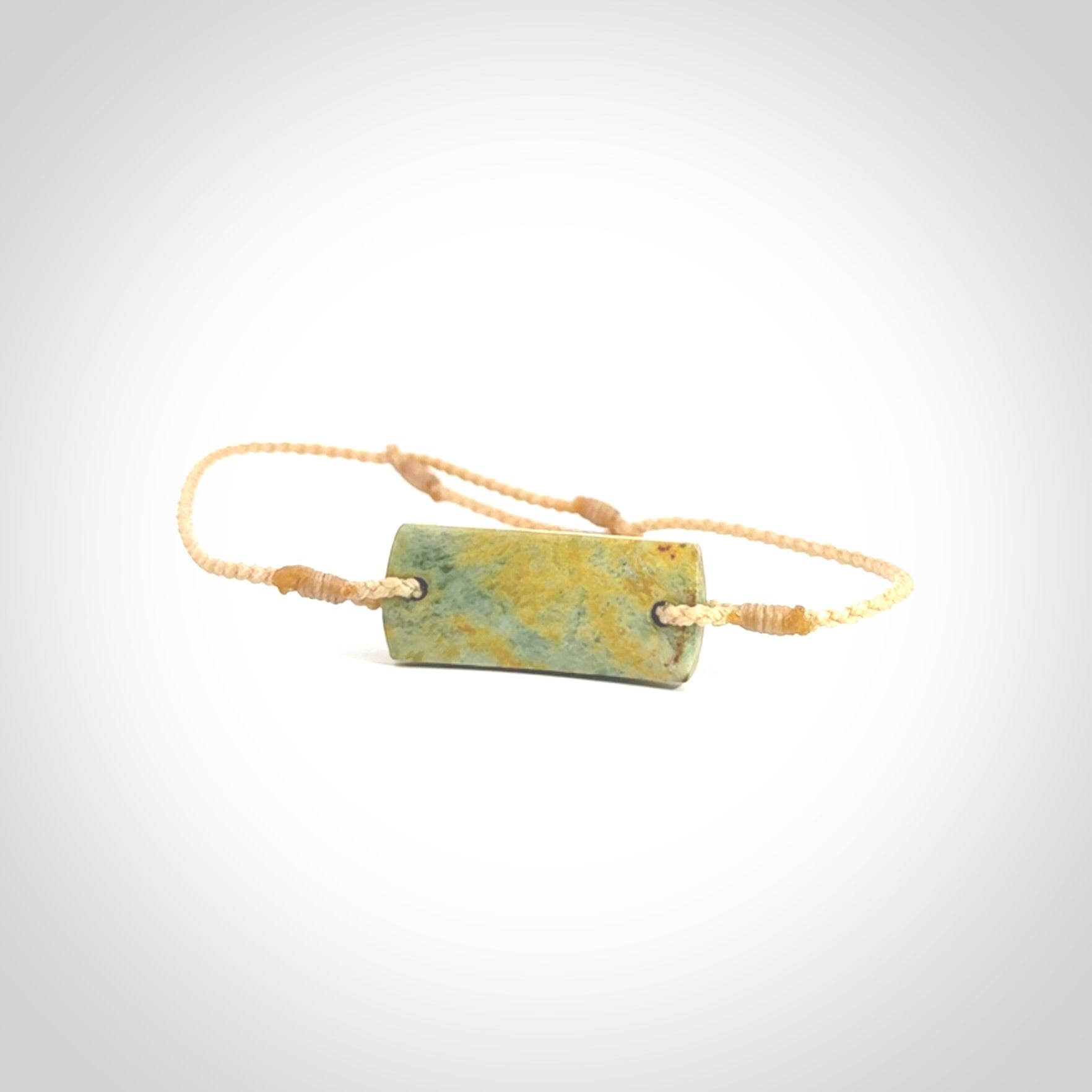 Hand carved New Zealand flower jade adjustable bracelet with beige cord. Carved in New Zealand jade by Ric Moor for NZ Pacific. One only armband for women and men.
