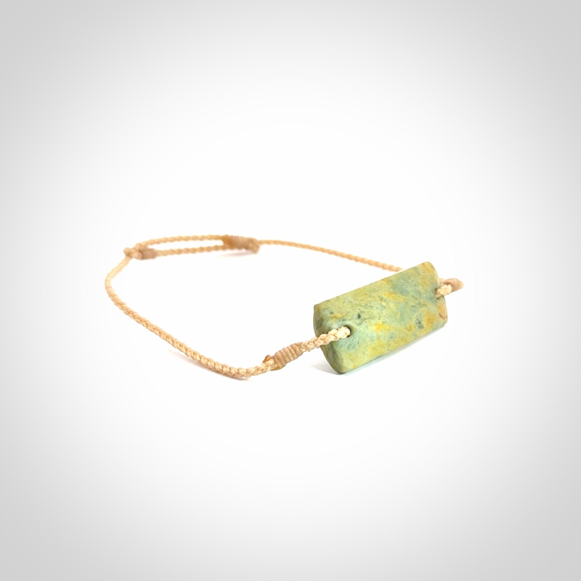 Hand carved New Zealand flower jade adjustable bracelet with beige cord. Carved in New Zealand jade by Ric Moor for NZ Pacific. One only armband for women and men.
