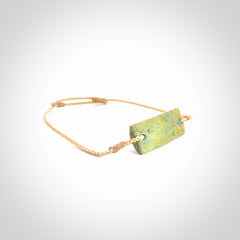 Hand carved New Zealand flower jade adjustable bracelet with beige cord. Carved in New Zealand jade by Ric Moor for NZ Pacific. One only armband for women and men.