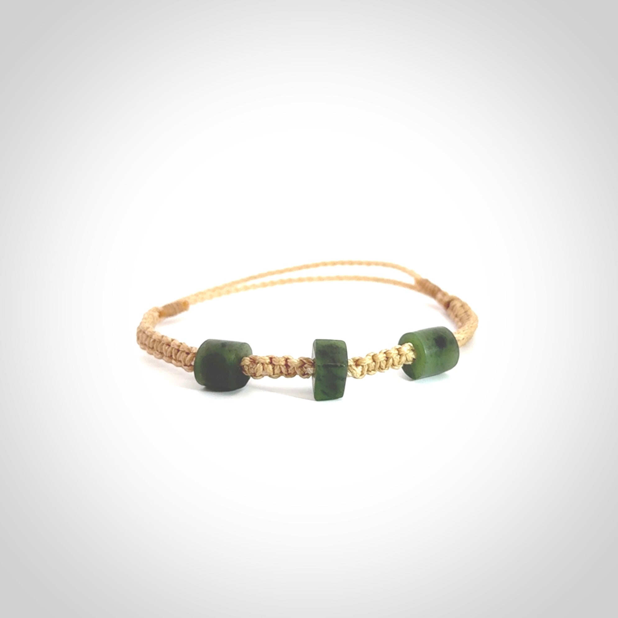 Hand carved New Zealand jade adjustable bracelet with beige cord. Carved in New Zealand jade by Ric Moor for NZ Pacific. One only armband for women and men.