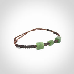 Hand carved New Zealand jade adjustable bracelet with brown cord. Carved in New Zealand jade by Ric Moor for NZ Pacific. One only armband for women and men.