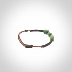 Hand carved New Zealand jade adjustable bracelet with brown cord. Carved in New Zealand jade by Ric Moor for NZ Pacific. One only armband for women and men.