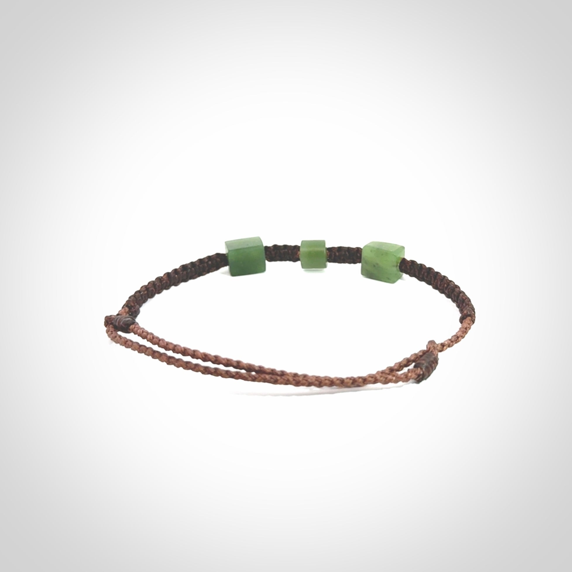 Hand carved New Zealand jade adjustable bracelet with brown cord. Carved in New Zealand jade by Ric Moor for NZ Pacific. One only armband for women and men.