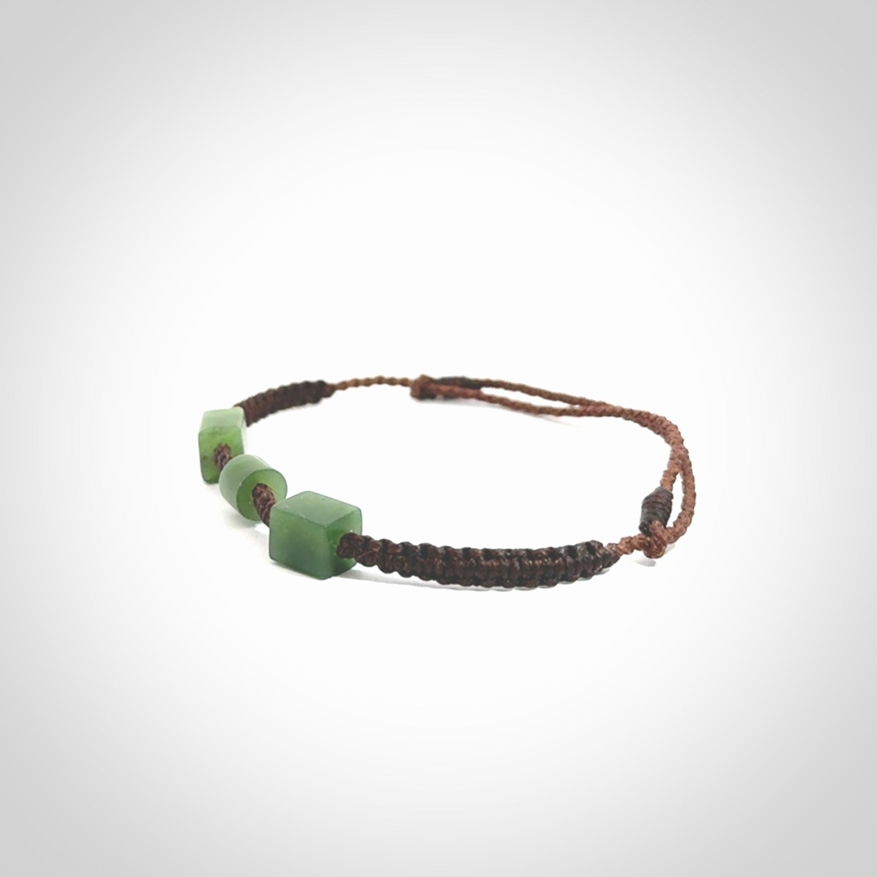 Hand carved New Zealand jade adjustable bracelet with brown cord. Carved in New Zealand jade by Ric Moor for NZ Pacific. One only armband for women and men.