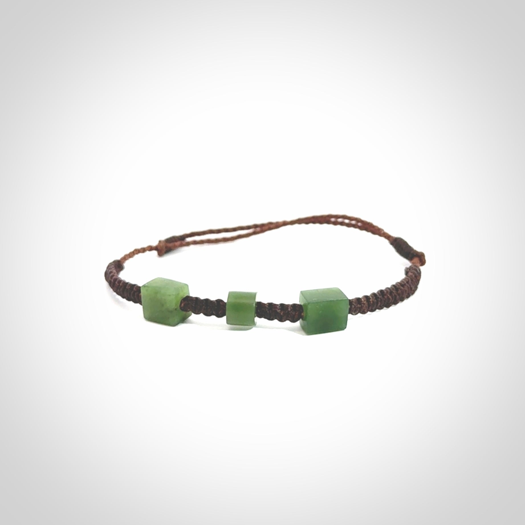 Hand carved New Zealand jade adjustable bracelet with brown cord. Carved in New Zealand jade by Ric Moor for NZ Pacific. One only armband for women and men.
