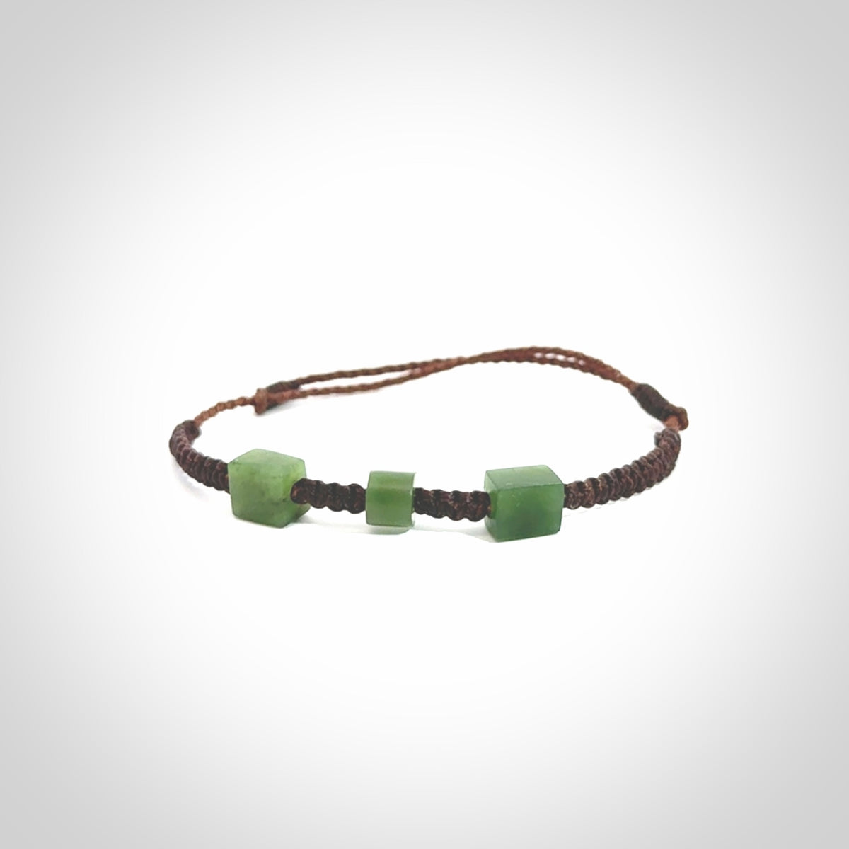 Hand carved New Zealand jade adjustable bracelet with brown cord. Carved in New Zealand jade by Ric Moor for NZ Pacific. One only armband for women and men.