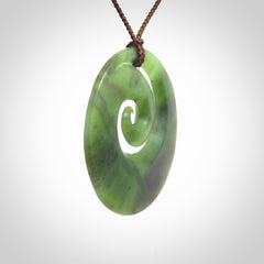This picture shows a hand carved New Zealand jade koru pendant