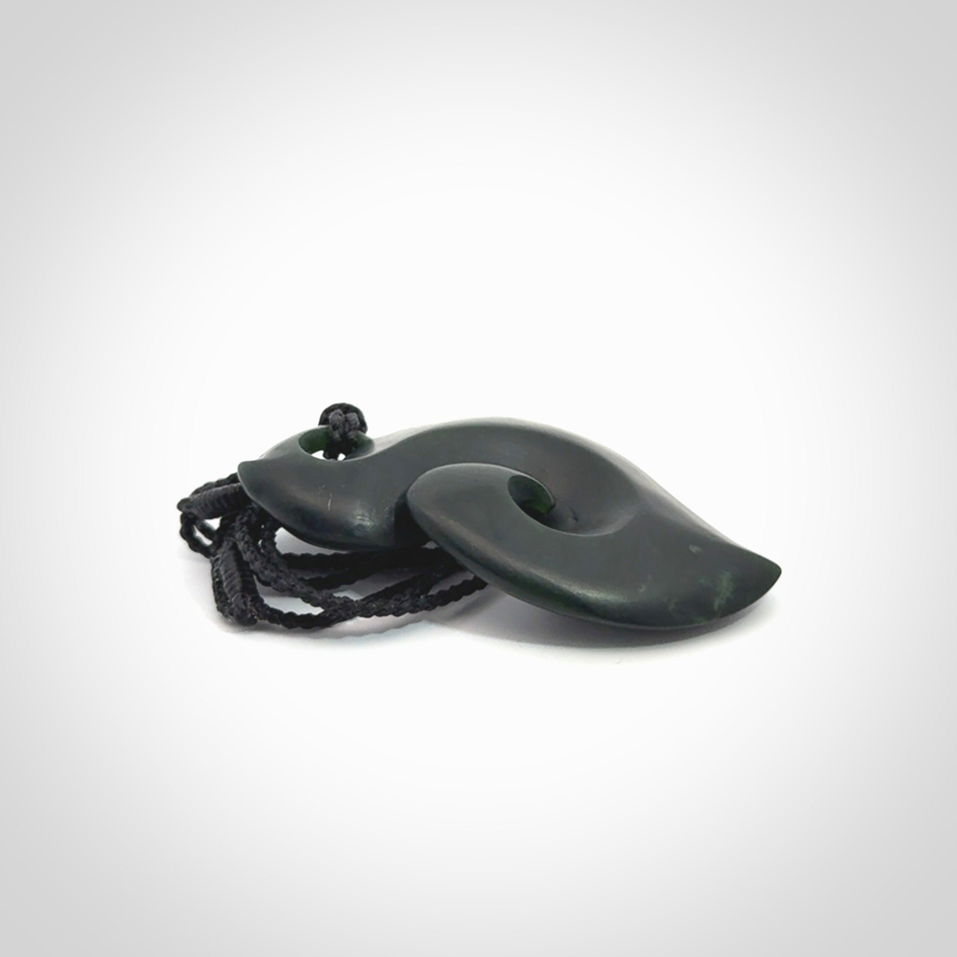 A hand carved New Zealand Jade contemporary koru pendant.