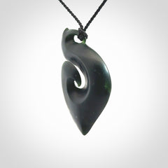 A hand carved New Zealand Jade contemporary koru pendant.