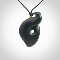 A hand carved New Zealand Jade contemporary koru pendant.