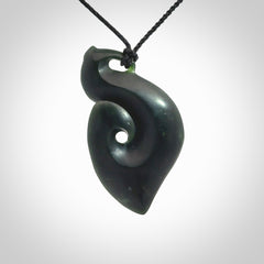 A hand carved New Zealand Jade contemporary koru pendant.