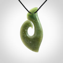 This picture shows a hand carved jade koru pendant. It is a deep green colour and is a wonderful, piece of jewellery. The cord is a four plait black colour and adjustable so that you can position the pendant where it suits you best. Delivery is free worldwide.