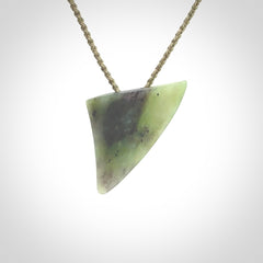 This is a lovely New Zealand Jade, pounamu niho drop pendant. It is bound with an adjustable khaki coloured cord which is length adjustable.