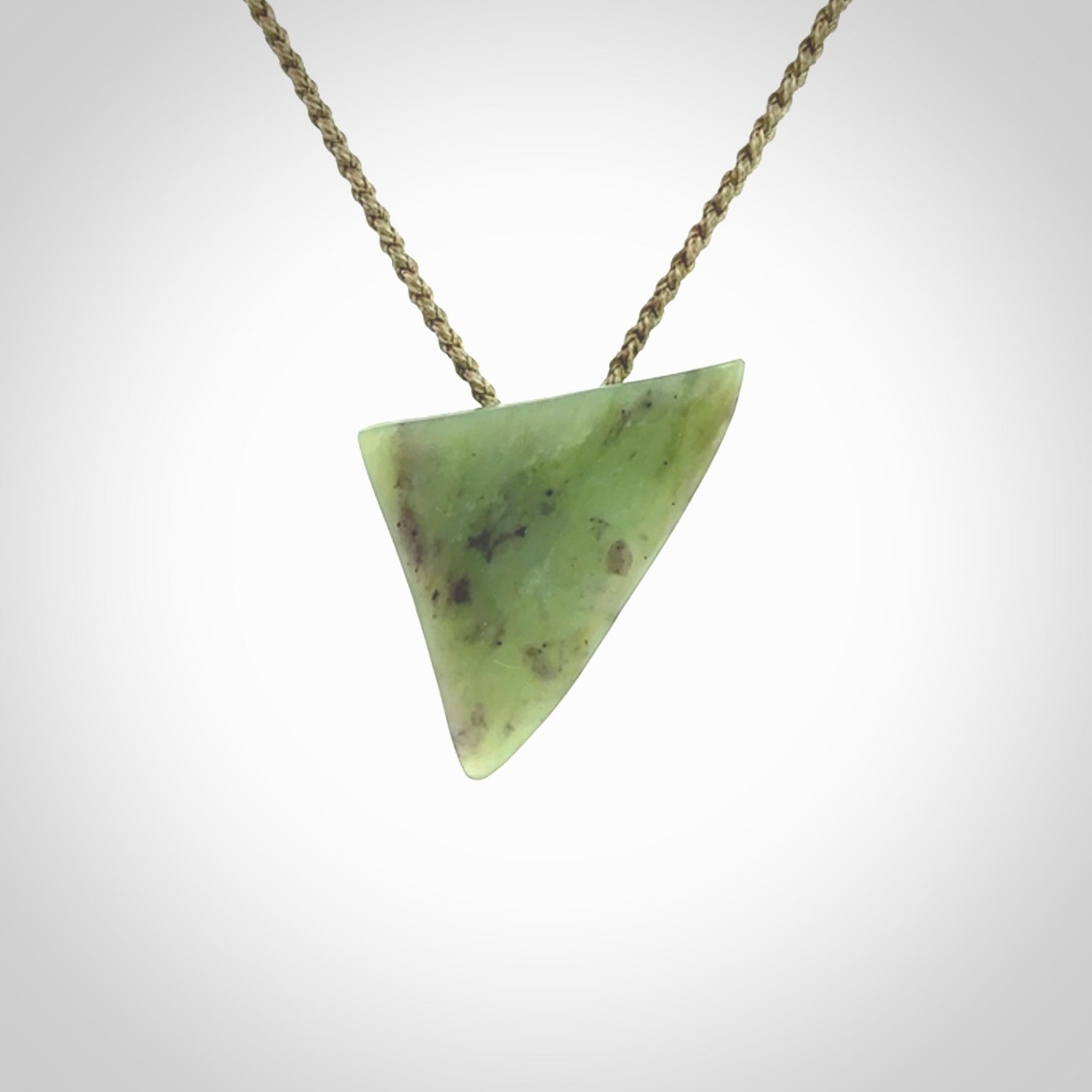This is a lovely New Zealand Jade, pounamu niho drop pendant. It is bound with an adjustable khaki coloured cord which is length adjustable.