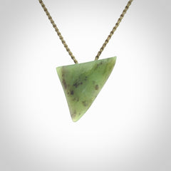 This is a lovely New Zealand Jade, pounamu niho drop pendant. It is bound with an adjustable khaki coloured cord which is length adjustable.
