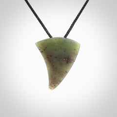 This is a lovely New Zealand Jade, pounamu niho drop pendant. It is bound with an adjustable black coloured cord which is length adjustable.