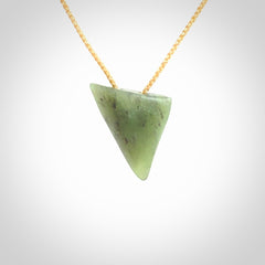 This is a lovely New Zealand Jade, pounamu niho drop pendant. It is bound with an adjustable beige coloured cord which is length adjustable.