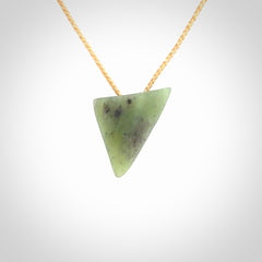 This is a lovely New Zealand Jade, pounamu niho drop pendant. It is bound with an adjustable beige coloured cord which is length adjustable.