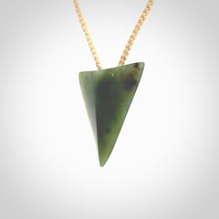 This is a lovely New Zealand Jade, pounamu niho drop pendant. It is bound with an adjustable beige coloured cord which is length adjustable.