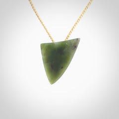 This is a lovely New Zealand Jade, pounamu niho drop pendant. It is bound with an adjustable beige coloured cord which is length adjustable.