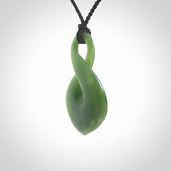 This piece is a fine, delicate drop shaped, single twist pendant. It was carved for us by Ric Moor from a lovely deep green piece of New Zealand jade. It is suspended on an black four plaited braided cord that is length adjustable.