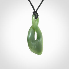 This piece is a fine, delicate drop shaped, single twist pendant. It was carved for us by Ric Moor from a lovely deep green piece of New Zealand jade. It is suspended on an black four plaited braided cord that is length adjustable.