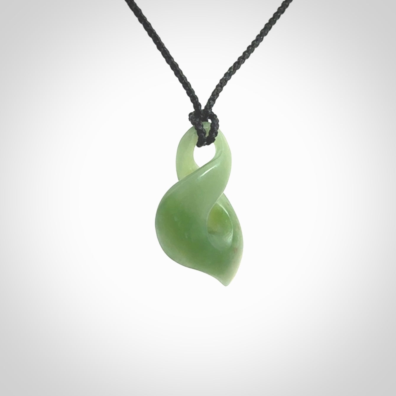 Hand carved small sized, New Zealand Inanga jade twist pendant.