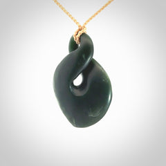 This piece is a drop shaped, single twist pendant. It was carved for us by Ric Moor from a lovely deep green piece of New Zealand jade. It is suspended on an beige four plaited braided cord that is length adjustable.