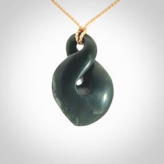 This piece is a drop shaped, single twist pendant. It was carved for us by Ric Moor from a lovely deep green piece of New Zealand jade. It is suspended on an beige four plaited braided cord that is length adjustable.