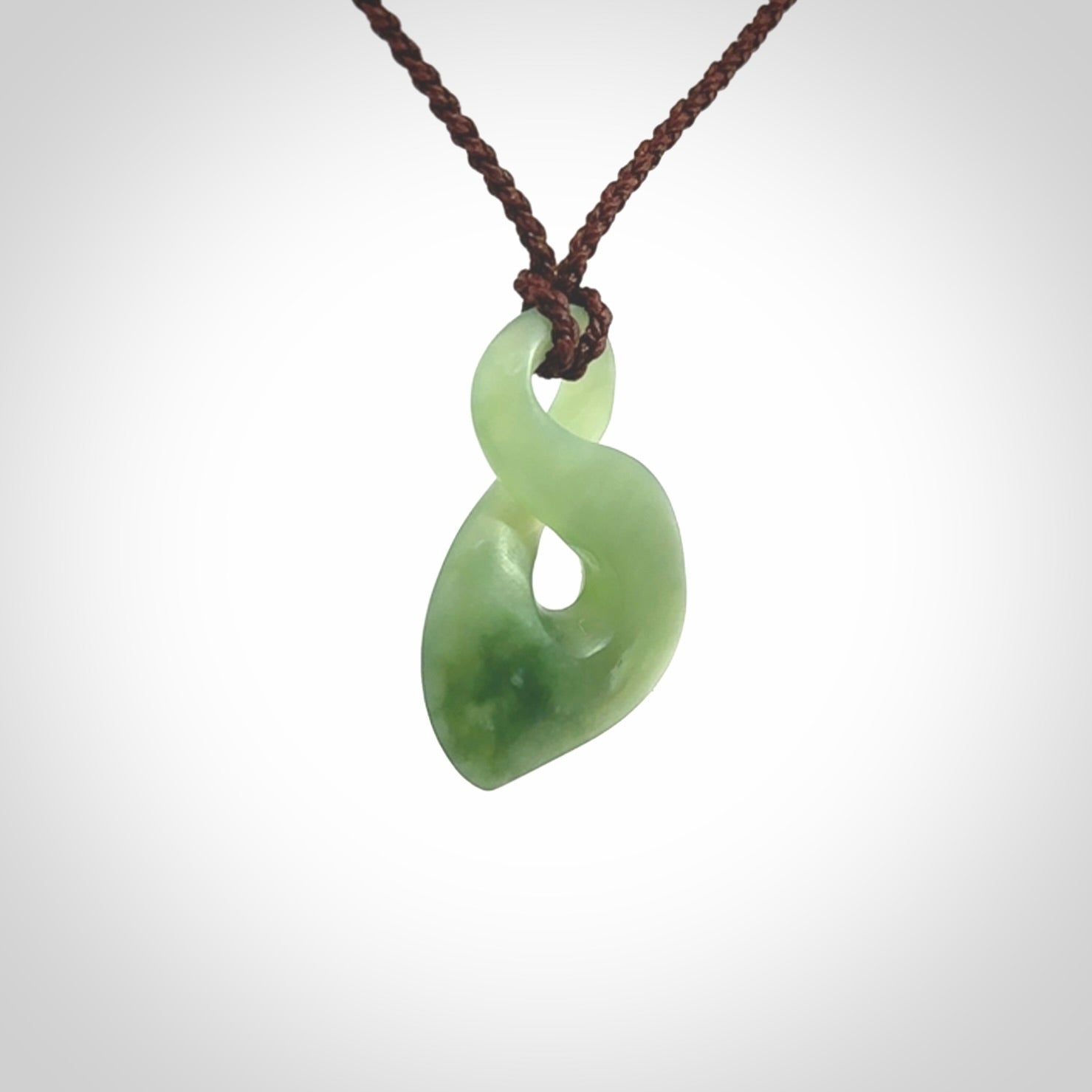 Hand carved small New Zealand Inanga jade twist pendant.