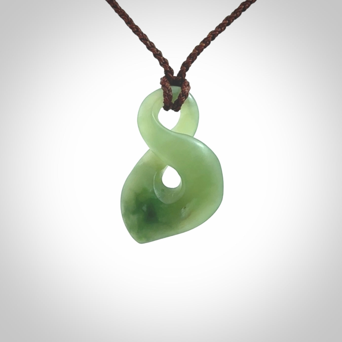 Hand carved small New Zealand Inanga jade twist pendant.