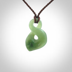 Hand carved small New Zealand Inanga jade twist pendant.