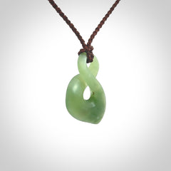 Hand carved small New Zealand Inanga jade twist pendant.