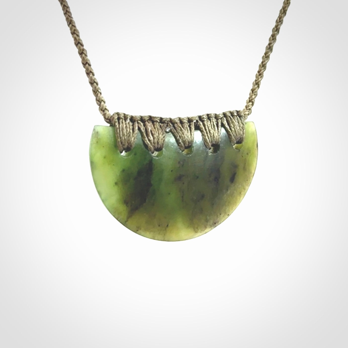 Hand carved pounamu small shield drop pendant. Jade necklace hand made in New Zealand. A contemporary drop pendant carved from rare New Zealand jade.