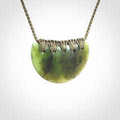 Hand carved pounamu small shield drop pendant. Jade necklace hand made in New Zealand. A contemporary drop pendant carved from rare New Zealand jade.