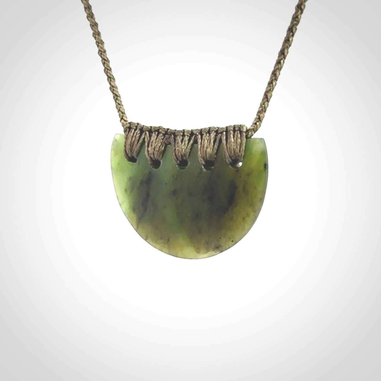 Hand carved pounamu small shield drop pendant. Jade necklace hand made in New Zealand. A contemporary drop pendant carved from rare New Zealand jade.