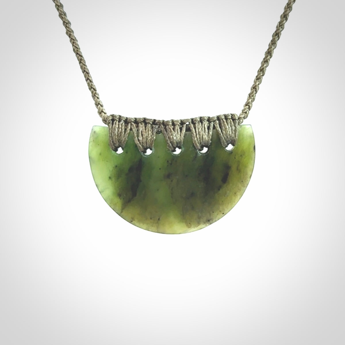Hand carved pounamu small shield drop pendant. Jade necklace hand made in New Zealand. A contemporary drop pendant carved from rare New Zealand jade.