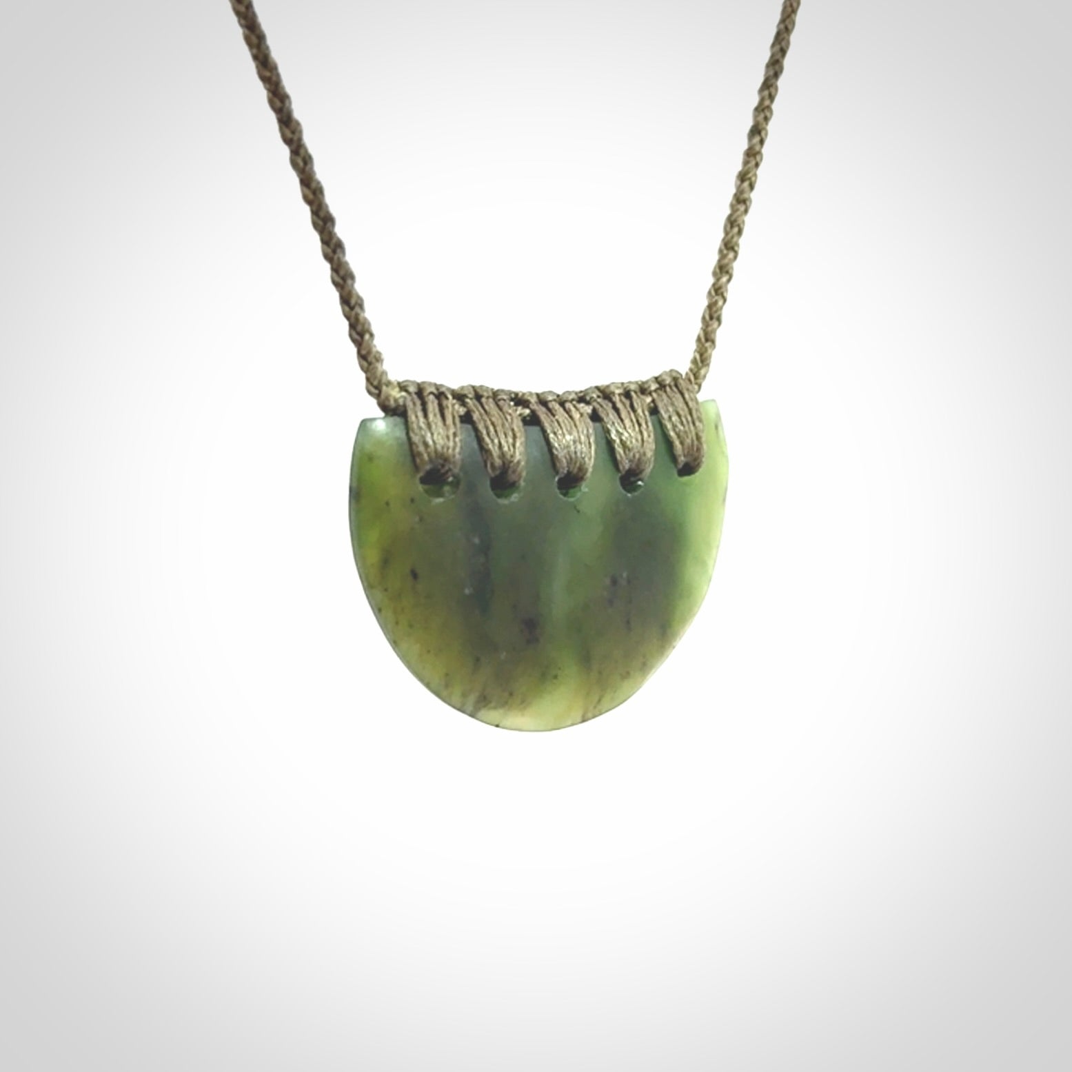 Hand carved pounamu small shield drop pendant. Jade necklace hand made in New Zealand. A contemporary drop pendant carved from rare New Zealand jade.