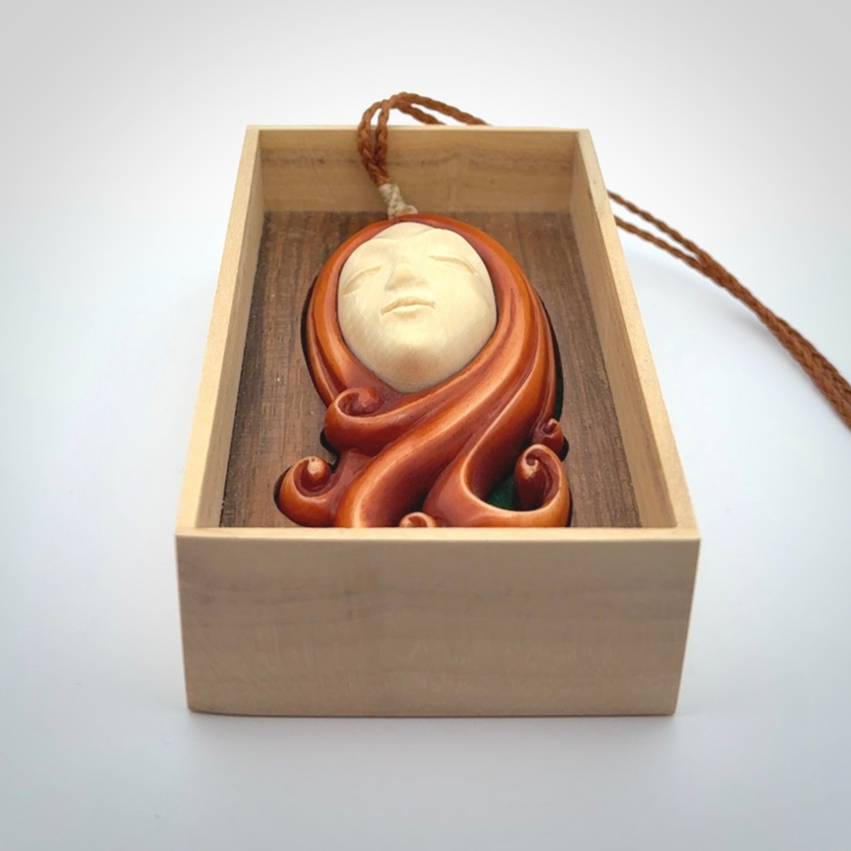This is a hand carved bone contemporary female pendant. Yuri Terenyi has carved this from Stained Bone with Woolly Mammoth Tusk and Paua Shell inlay on the back of the pendant. It is a delightful, large and artistic piece of jewellery. One only necklace. The necklace is provided on an adjustable cord in a hand made, custom, wooden box.
