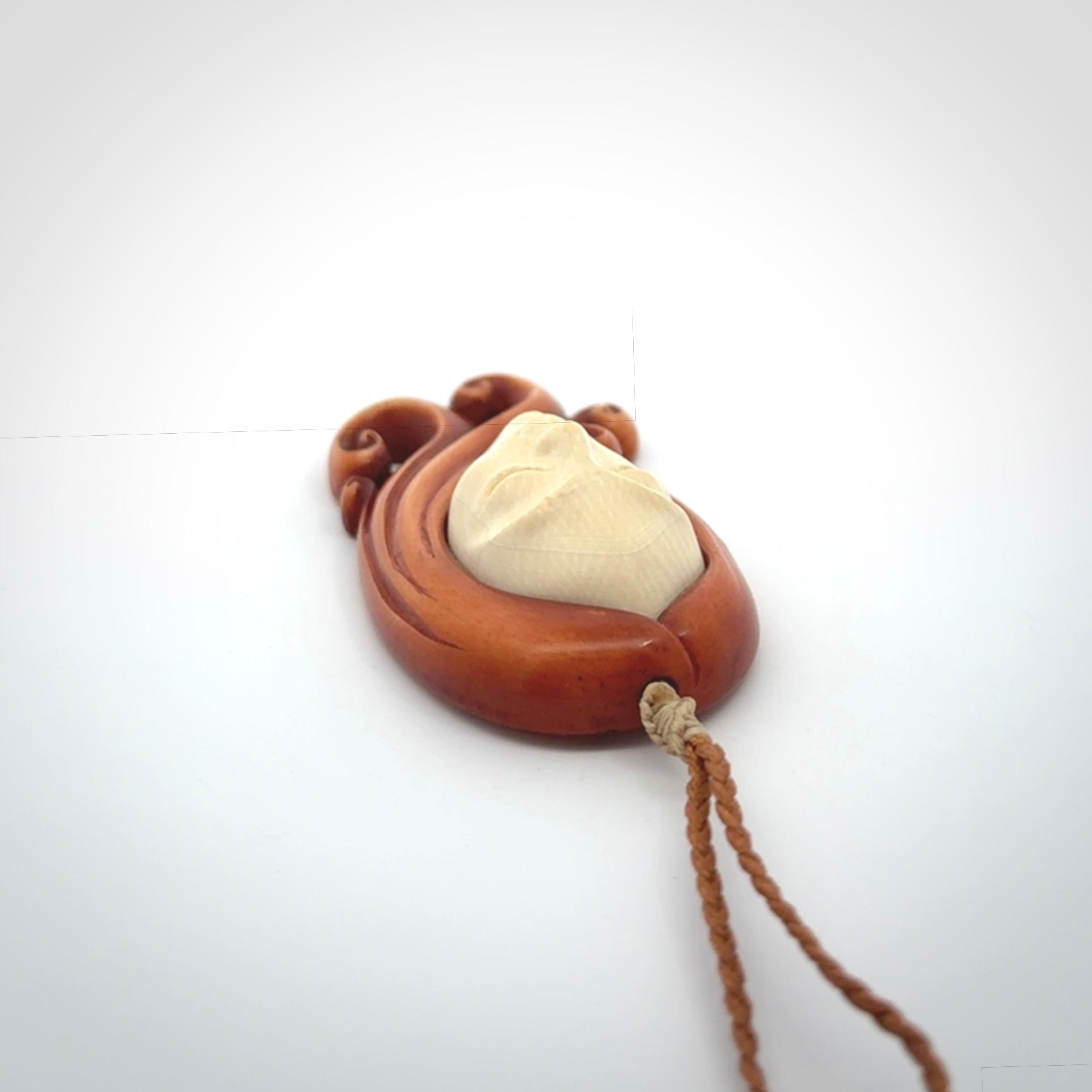 This is a hand carved bone contemporary female pendant. Yuri Terenyi has carved this from Stained Bone with Woolly Mammoth Tusk and Paua Shell inlay on the back of the pendant. It is a delightful, large and artistic piece of jewellery. One only necklace. The necklace is provided on an adjustable cord in a hand made, custom, wooden box.