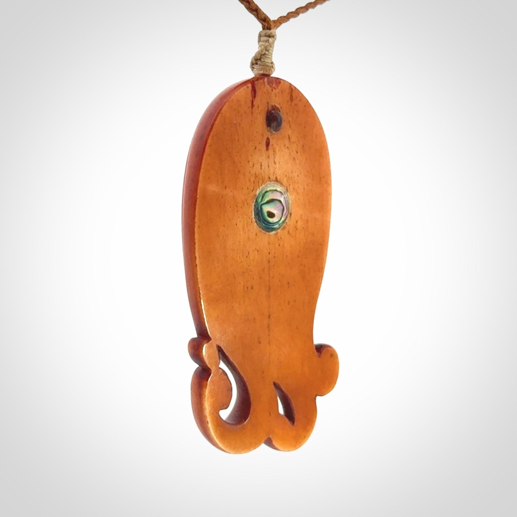 This is a hand carved bone contemporary female pendant. Yuri Terenyi has carved this from Stained Bone with Woolly Mammoth Tusk and Paua Shell inlay on the back of the pendant. It is a delightful, large and artistic piece of jewellery. One only necklace. The necklace is provided on an adjustable cord in a hand made, custom, wooden box.