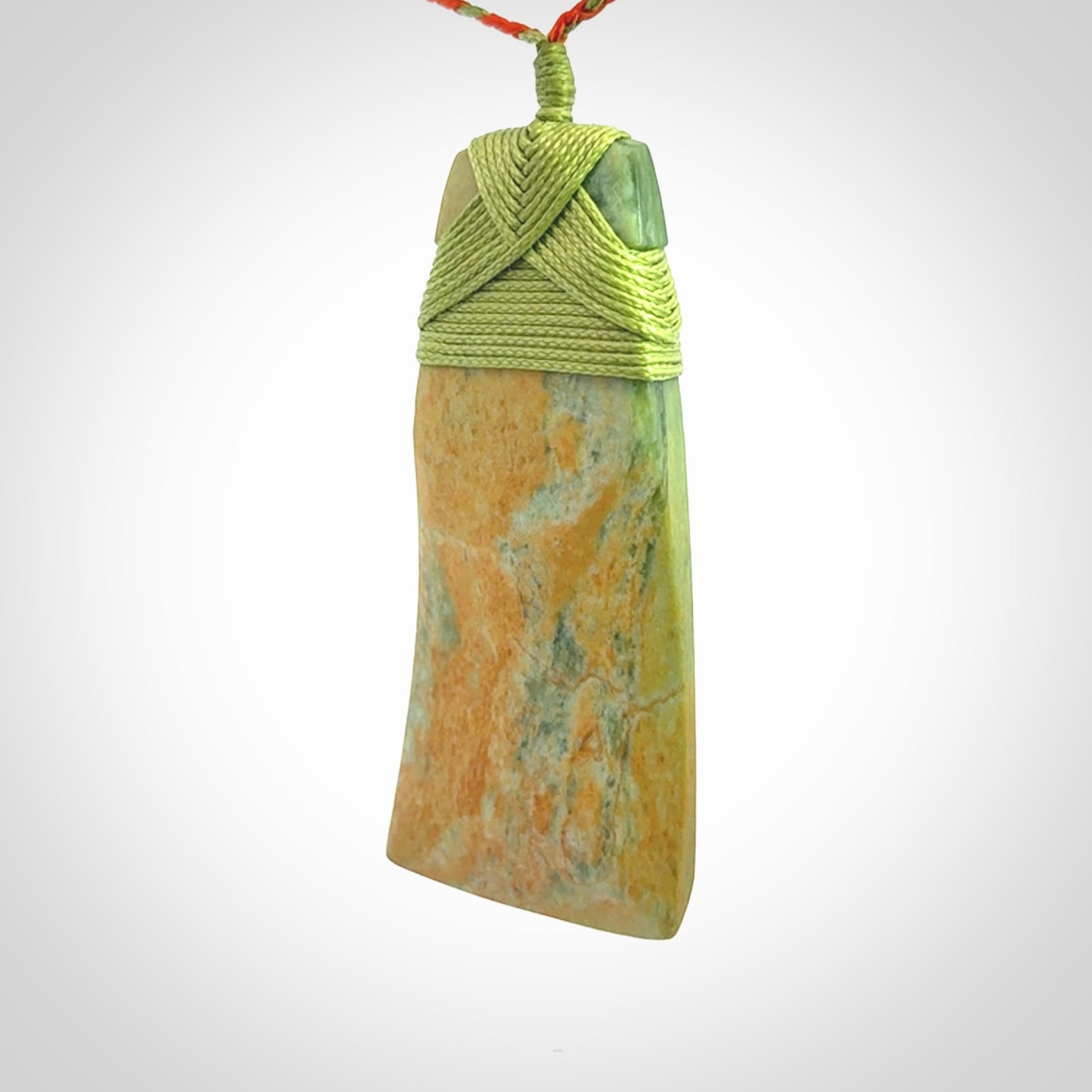 Hand carved Toki pendant from a lovely piece of local New Zealand Flower Jade. We have suspended this from a orange and green cord which can be adjusted with a couple of slip knots and green binding.