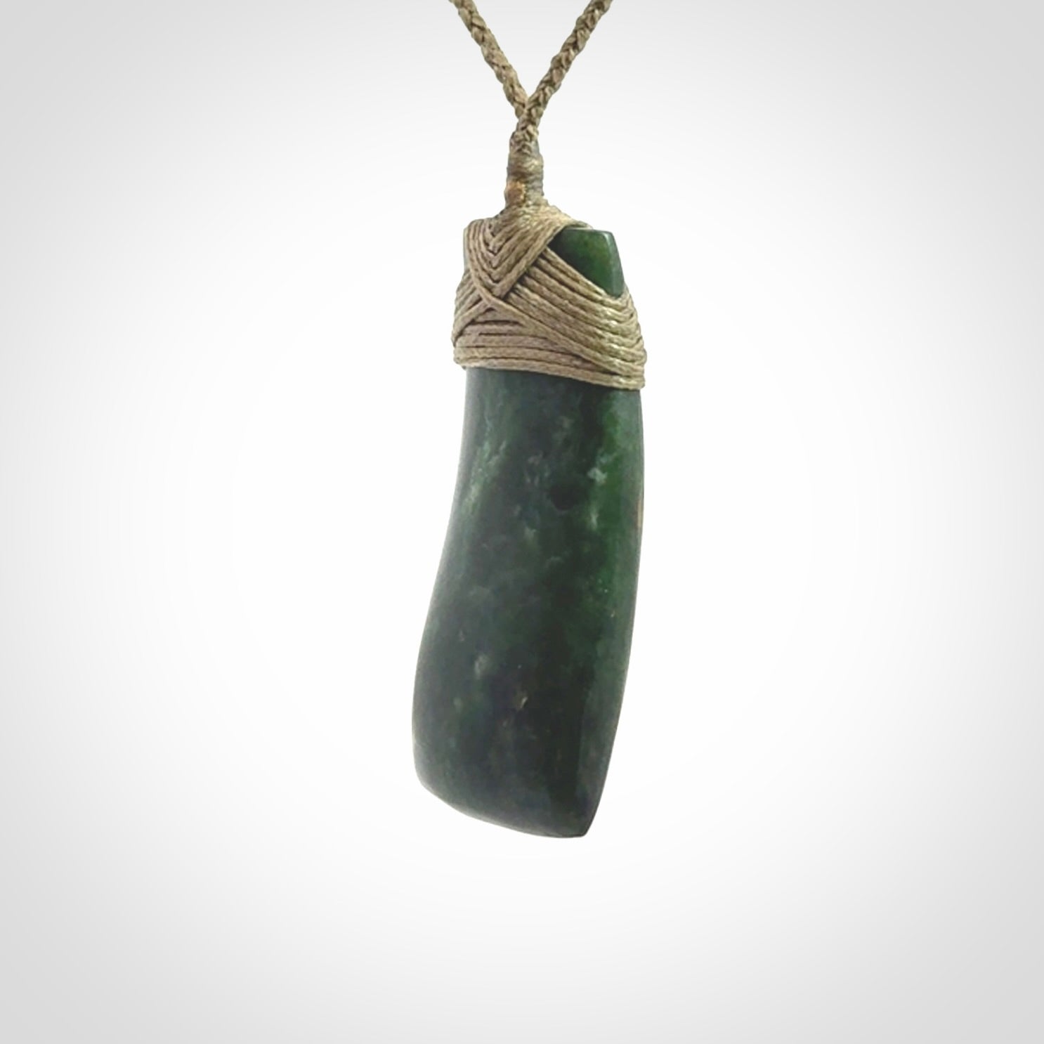 Hand carved Toki pendant from a lovely piece of local New Zealand Jade. We have suspended this from a 4-plait olive cord which can be adjusted with a couple of slip knots and olive binding.